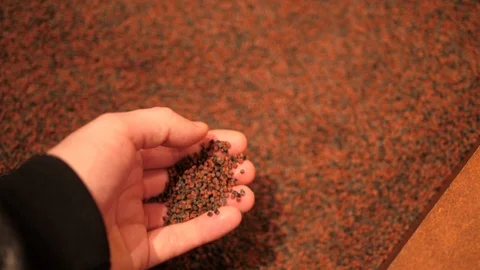 Basalt Pellets Material in hand. 3D printing on Mars, AI SpaceFactory, 2019 Stock Footage 124424793