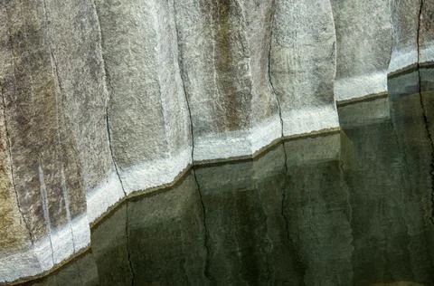 Basalt pillars texture in water. Close-up. 写真素材