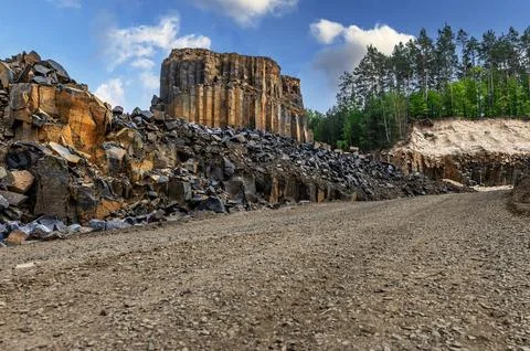 Basalt quarry. Columnar basalt quarry in summer. Volcanic stones. Geologic .. Stock Photos