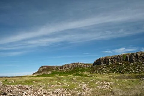 Basalt rock cliffs with meadows leading up to them on the Isle of Mull, Scotland Stock Photos