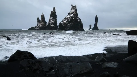 Basalt rocks Troll toes on black beach. at storm Reynisdrangar, Vik, Iceland. Stock-Footage 108206348