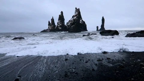 Basalt rocks Troll toes on black beach. at storm Reynisdrangar, Vik, Iceland. Stock Footage 124906441