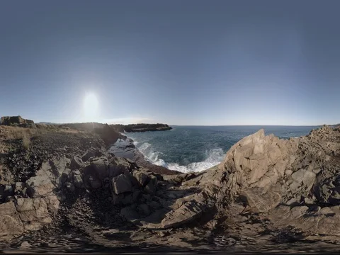 Basalt sea cliff overlooking waves crashing on rock shelf 360 Standing height Stock Footage
