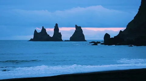 The basalt sea stacks situated under the mountain Reynisfjall Stock Footage 52085090