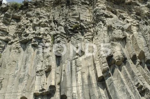 Basalt wall near the road Stock Photos