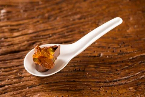 Base of biscuit, mango and passion fruit gel, half bitter chocolate mousse .. Stock Photos