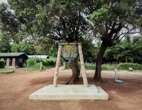 The base camp sign post. guides porters and sherpas carry heavy sacks as they Stock Photos