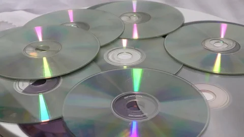 The base cds and dvds moving in round motion on white Stock Footage 111887891