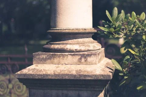 Base of a column, pillar closeup with garden background Stock Photos