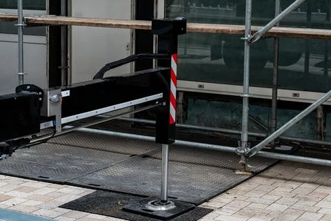Base of a construction crane against the backdrop of scaffolding. Stock Photos