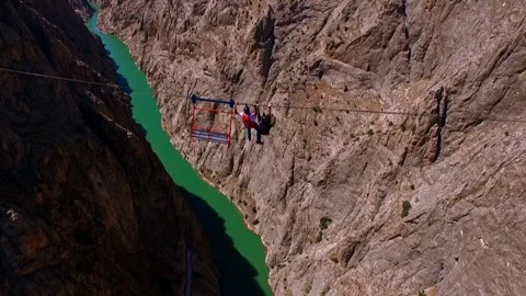 Base Jump and Zipline Above Turquoise River Stock Footage 309483669