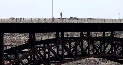 A BASE jumper jumps from Perrine Bridge, Snake River, Idaho. Stock Footage 131495361
