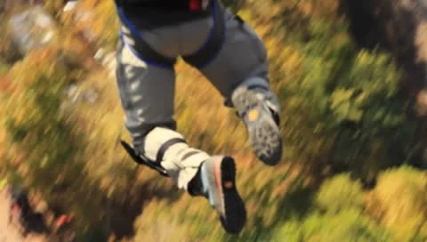 Base jumper opening parachute over the New River Stock Footage 8848466