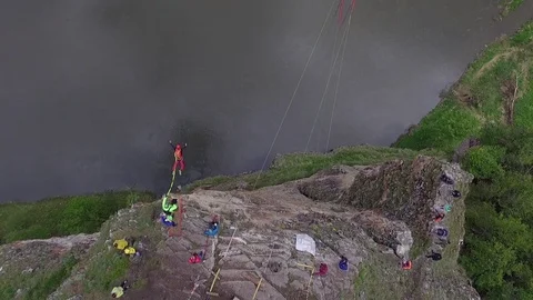 Base jumpers with high cliffs above the river. The Ural Mountains. Shooting from Stock Footage 76181320