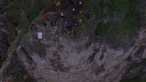 Base jumpers with high cliffs above the river. The Ural Mountains. Shooting from Stock Footage 76181479