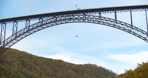 Base Jumpers Parachuting Off a Bridge, Slow Motion Stock Footage 127466460