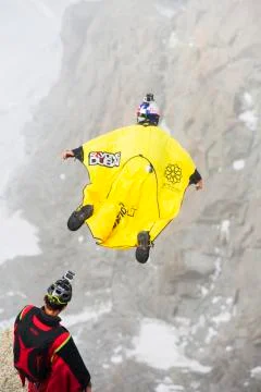 Base jumpers wearing wing suites jump from the Aiguille Du midi above Chamonix, Stock Photos