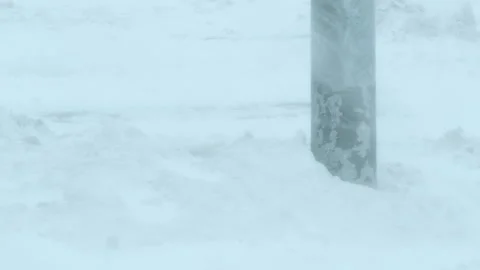 Base of a lamppost in a snowstorm. Stock Footage 332876545