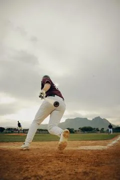 Base runner making a sprint for a triple in a scenic baseball stadium with .. Stock Photos