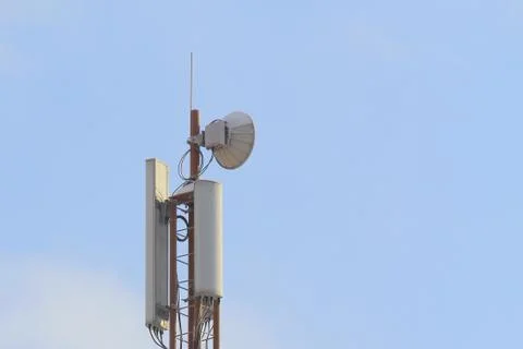 Base station mobile network antenna on a steel structure mast with a repeater Stock Photos
