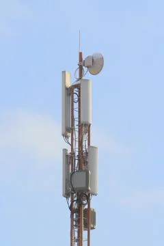 Base station mobile network antenna on a steel structure mast with a repeater Stock Photos