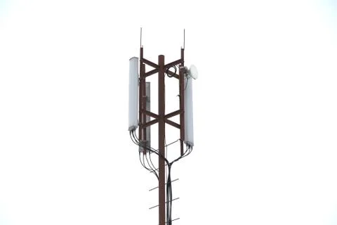 Base station mobile network antenna on a steel structure mast with a repeater Stock Photos