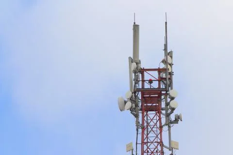Base station mobile network antenna on a steel structure mast with a repeater Stock Photos
