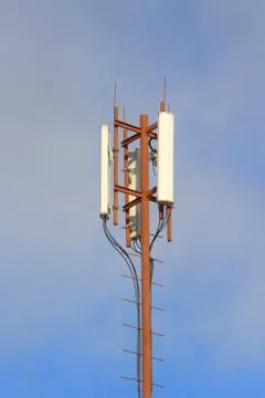 Base station mobile network antenna on a steel structure mast with a repeater Stock Photos