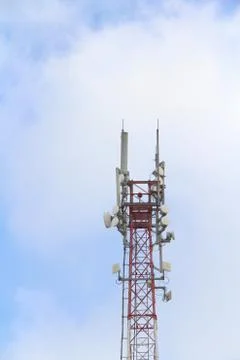 Base station mobile network antenna on a steel structure mast with a repeater Stock Photos