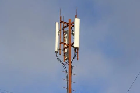 Base station mobile network antenna on a steel structure mast with a repeater Stock Photos