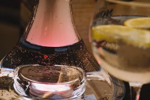 Base with water from a hookah with colored lights. Stock Photos