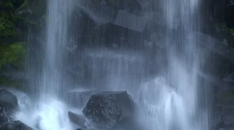 Base of waterfall with hexagonal rocks, zoom out and tilt up Stock Footage 38020686