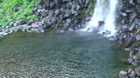 Base of waterfall with puddle, pan left to stream Stock Footage 38020558