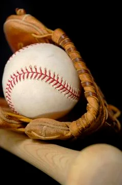 Baseball and bat on black Stock Photos