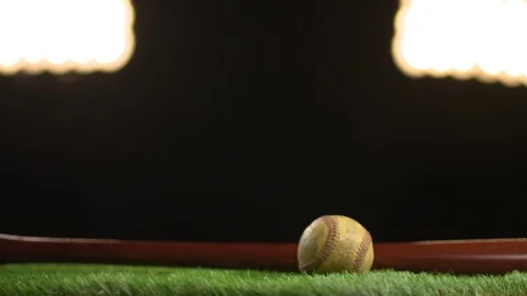 Baseball and bat spin on a turntable resplendent under stadium lights Stock Footage 72358887