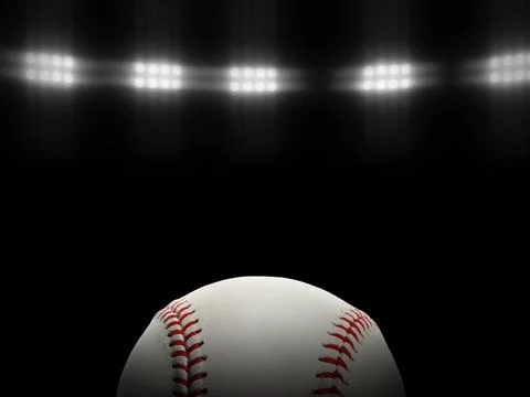 Baseball ball on a black background under stadium lights Stock Photos