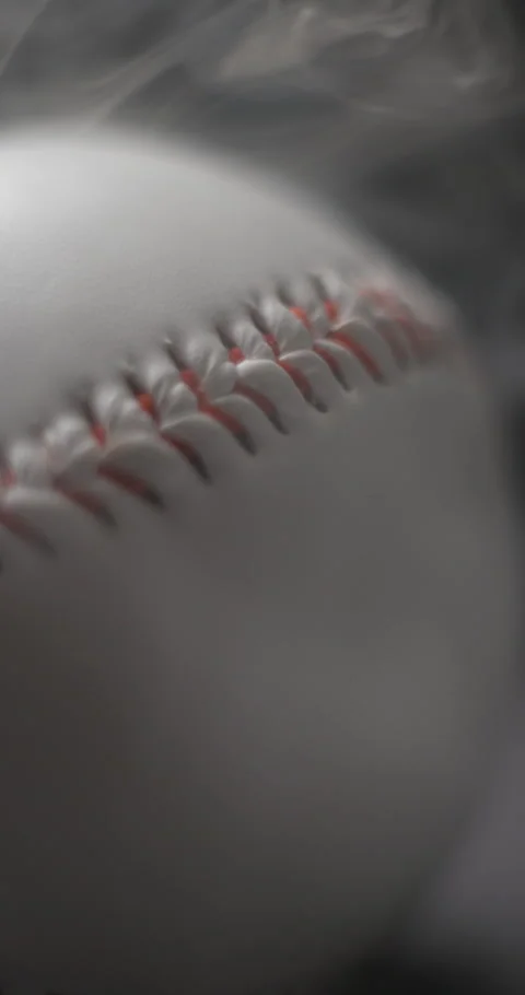 Baseball ball close-up rotating with smoke in studio slow motion, vertical view Stock Footage 281039608