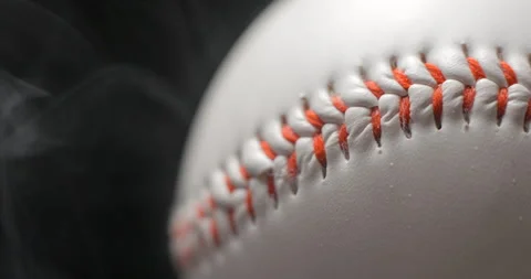 Baseball ball close up rotating in studio with smoke in slow motion Stock Footage 247513303