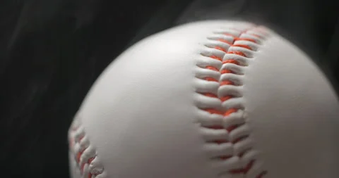 Baseball ball close up rotating in studio with smoke in slow motion Stock Footage 247513620