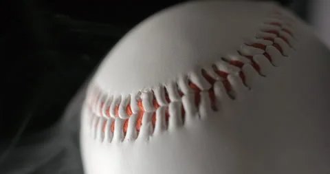 Baseball ball close up rotating in studio with smoke in slow motion, vertical Stock Footage 247514095