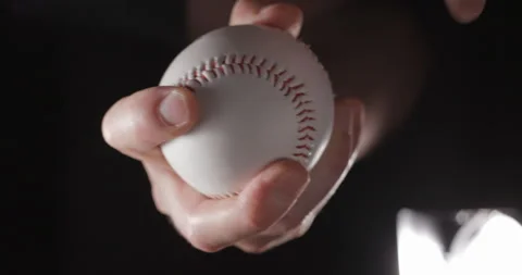 Baseball ball in studio close-up, macro, with smoke 4K, vertical slow-motion Stockbeeldmateriaal 246430975
