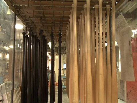 Baseball bats. Painted and finished. Hanging to dry B Stock Footage 102185080