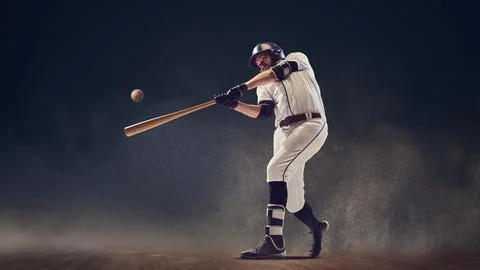Baseball batter making contact with ball through dust cloud showing explosive Stock Photos
