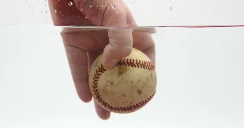 Baseball being held in hand isolated on white showing off baseball Stock Footage 219443659