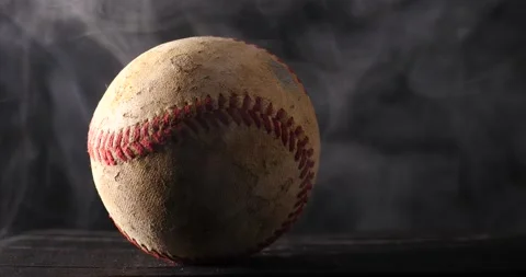 Baseball being placed down will smoke rising a background representing the sport Stock Footage 206836900