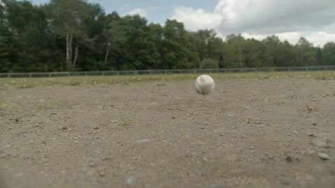 Baseball bouncing in front of camera in slow motion on rural field, 4k 動画素材 112273973
