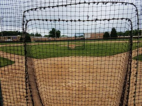 Baseball diamond with safety nets Stock Photos