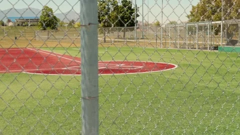 Baseball Diamond Viewed Through Chain Link Fence With Slow Pan Stock Footage 336757312