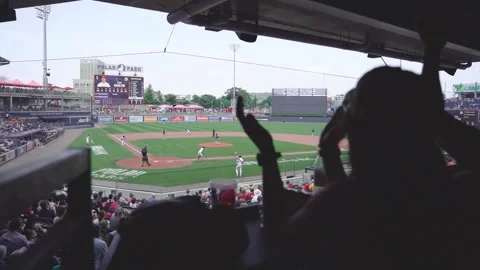 Baseball fans cheer as baseball player hits a flyball and scores a run Stock Footage 246879698
