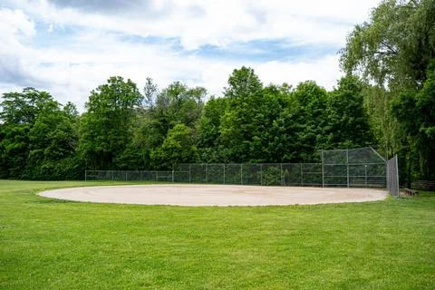 Baseball field backstop and bleachers in public park Stock Photos